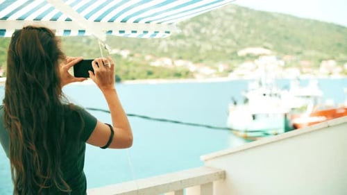 A Woman Takes Pictures of the Mediterranean Scenery