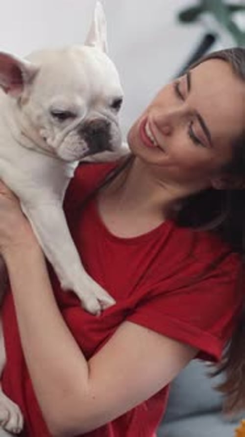 Affectionate Woman Cuddling Cute French Bulldog