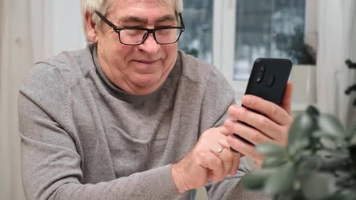 Senior Man Using Smartphone Indoors
