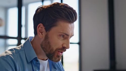 Bearded Man Talking and Gesturing During Office Meeting