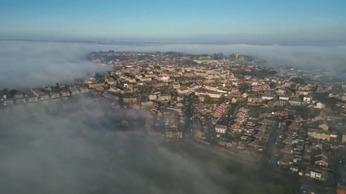 Aerial view of town city with residential buildings in earning fog and mist.