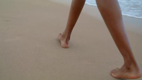 Slim Legs Walking Beach at Ocean Waves Closeup. Woman Stroll Leaving Footprints