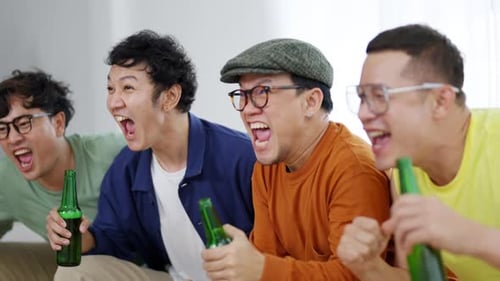 Enthusiastic Friends Cheering While Watching Television at Home