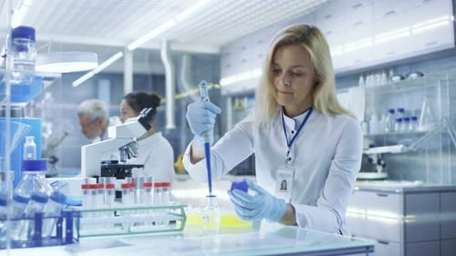 Woman Scientist Works in Bright Modern Laboratory