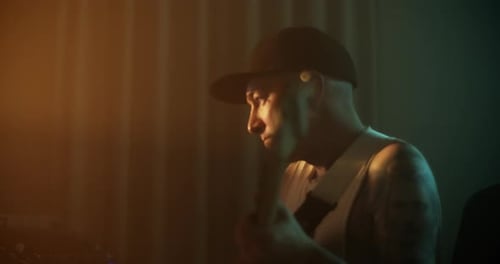 Man Plugging Out Cord of Guitar in Studio