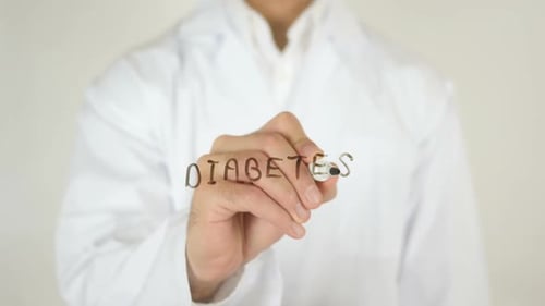 Doctor Writing Diabetes on Glass Surface