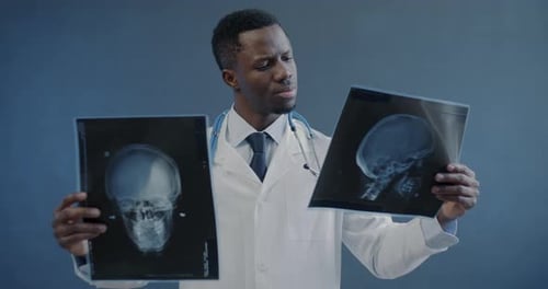 Focused Doctor Examining Skull X-rays
