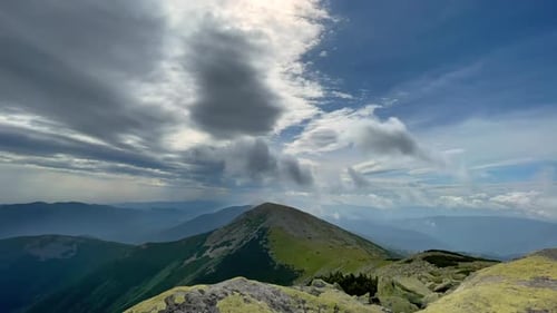 Majestic Mountain Range Under a Cloudy Sky