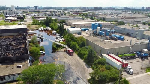 Fire Trucks In The Street Near The Industrial Burned Down In Toronto, Canada. - aerial
