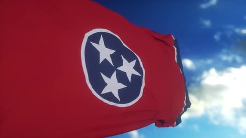Waving Tennessee State Flag Against Blue Sky