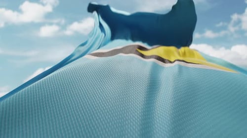 Waving Saint Lucia Flag Against Sunny Blue Sky