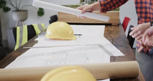 Architects Examine Building Plans in Office Setting