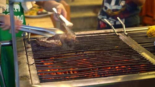 Steaks Cooking on a Grill at an Outdoor Restaurant