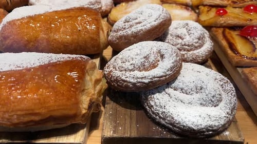 Delicious Pastries Covered in Powdered Sugar and Glaze