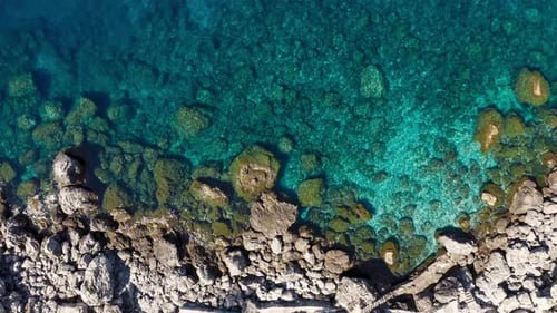 Aerial View of a Cliff on a Clear Sea in Summer