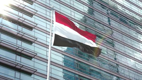 Waving Yemen Flag on Modern Building Background