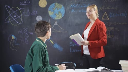 Teacher Explaining Science to Student in Classroom