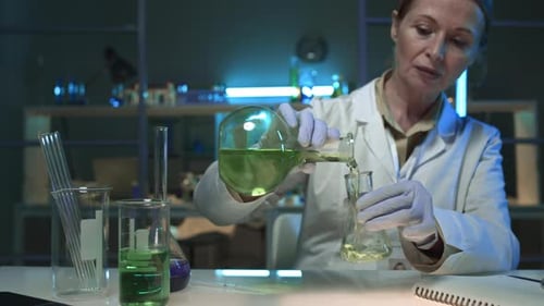 Portrait of Middle-Aged Female Scientist Working in Chemistry Lab