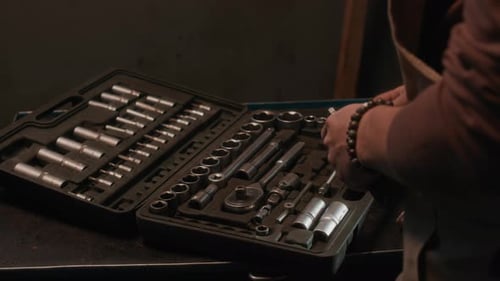 Hands of Mechanic Organizing Wrench Set for Repairing Tasks in Garage