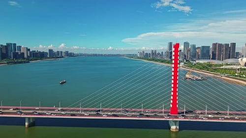 Aerial View of a Red Bridge Spanning the Qiantang River in Hangzhou Modern Buildings Define the City