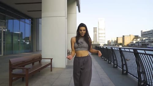 Young Woman Dances in Urban Setting