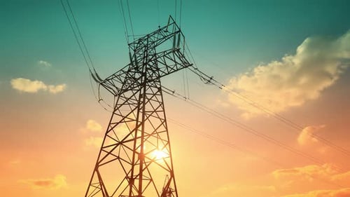 Dramatic Electrical Tower Silhouette During Golden Sunset
