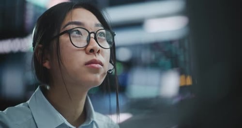 Stock Exchange Female Trader Makes Well Considered Calculated Investment Decisions in Equities