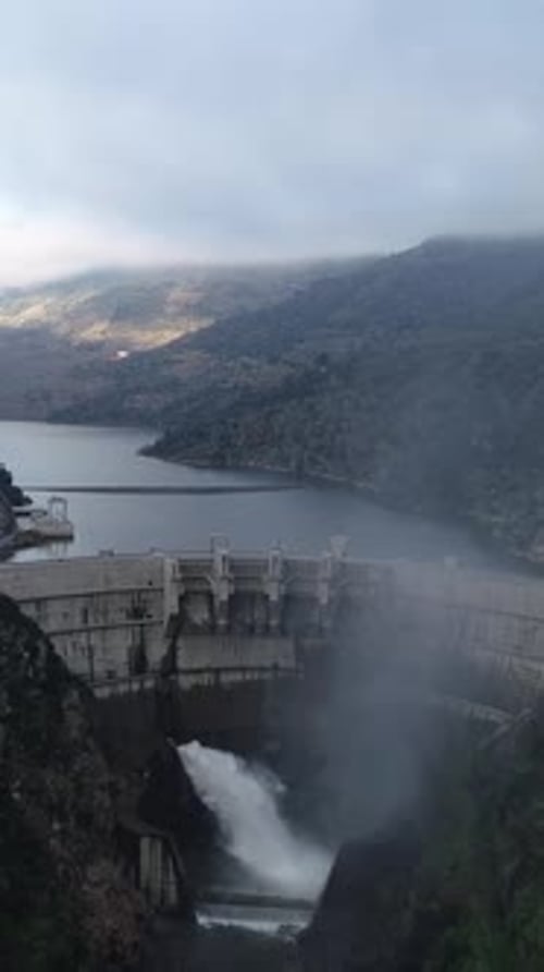 Vertical Video of Water dam in the mountains view from above