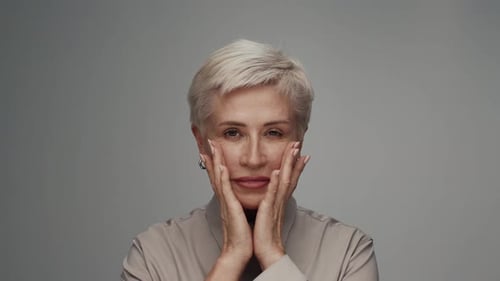 Elegant Senior Woman Posing with Hands on Face
