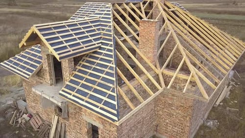 Aerial View of a House Under Construction Works Unfinished Brick Building with Wooden Frame for Roof
