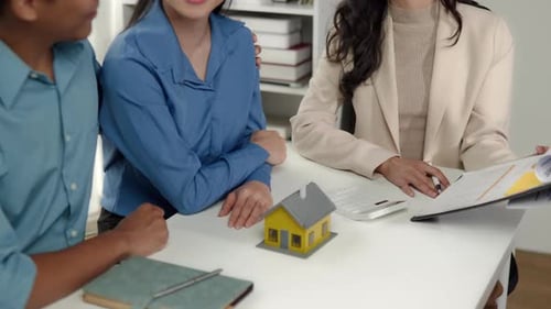 Business seller explain and calculate to wife and husband who buying real estate house properties.