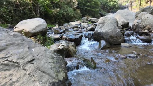View above small river with rocks