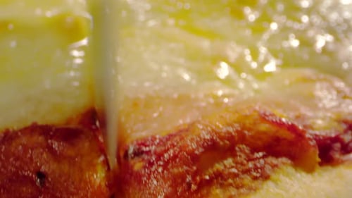 Knife Slicing Through Pepperoni Pizza Close Up