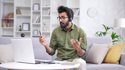 Adult Man on Laptop Video Meeting at Home