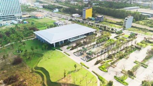 Aerial Perspective Revealing Sleek Convention Center Surrounded By Carefully Landscaped Gardens