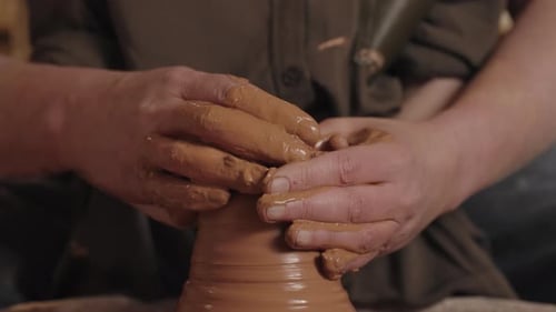 Hands Forming Clay on Pottery Wheel