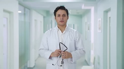 Doctor Holding Stethoscope in Clean Hospital Setting