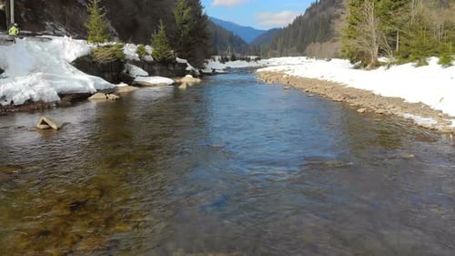 Low Flying Over the River in the Winter Mountains