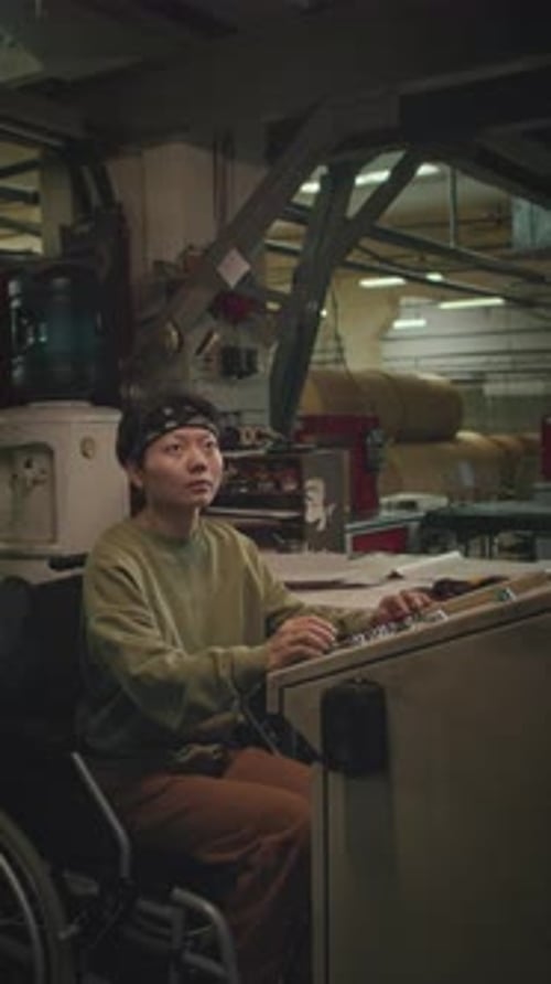 Female Factory Worker with Disability Operating Machine Equipment