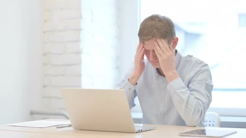 Young Adult Experiencing Headache While Using Laptop