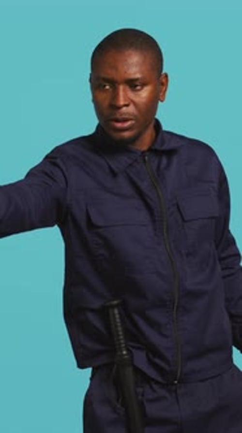 Man Gestures Stop with Hand in Uniform