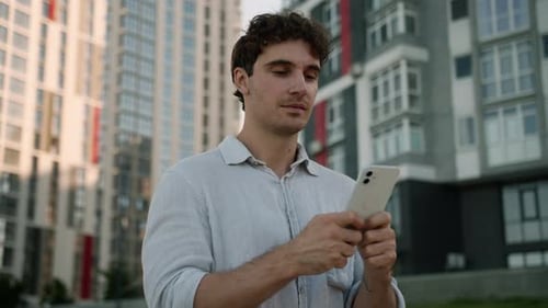 Happy Caucasian Young Man at City Male Using Chatting Mobile Phone Smartphone Guy Businessman