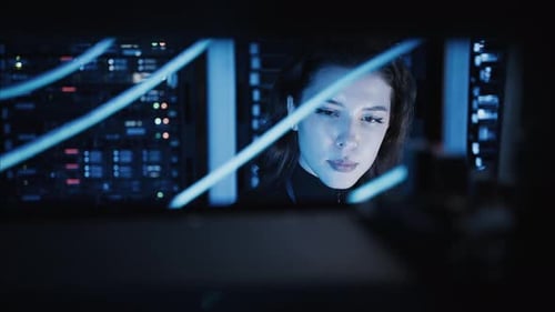 Woman programming in a server room