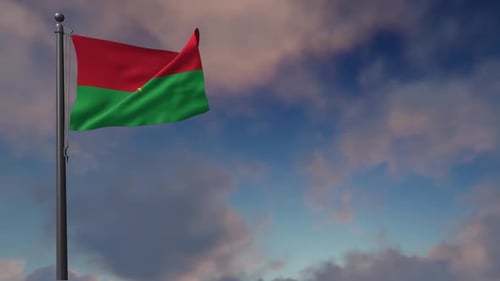 Burkina Faso Flag Waving in the Wind Against a Cloudy Sky