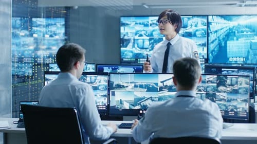 Security Team Reviewing Surveillance Video in Control Room