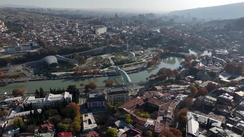 Aerial view of Tbilisi city central park and Bridge of Peace. Beautiful cityscape of old Tbilisi