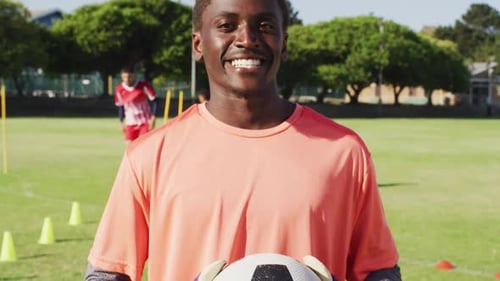 Video of african american male football players with ball on field