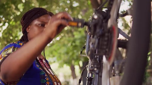 Female Checking Bicycle Performance