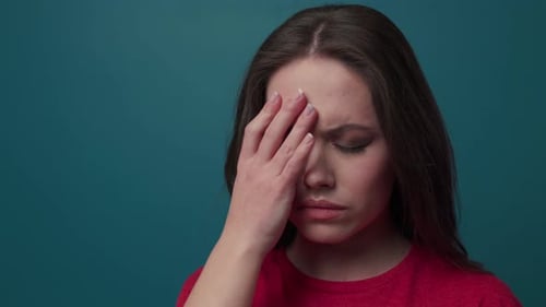 Close Up View of Young Woman Closing Her Eyes Touches Her Forehead Having a Headache Massages Her