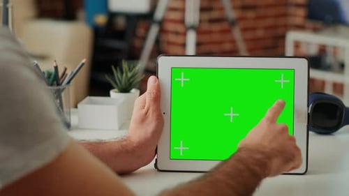 Man Interacting with Tablet Green Screen Indoors